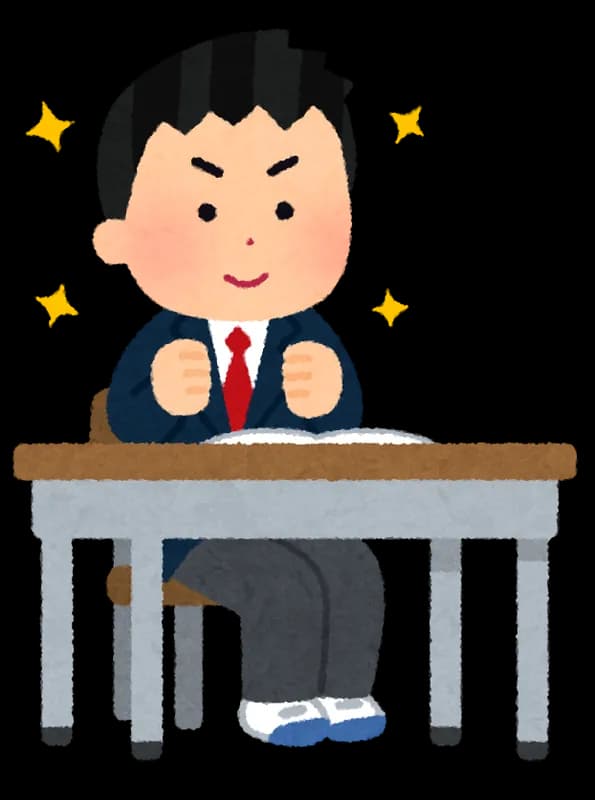 机に向かい、やる気に満ちた表情で拳を握っている制服姿の生徒のイラスト。